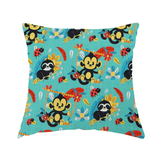 The fabric used to create this handmade cushion is a playful and vibrant children’s fabric featuring a repeat pattern of cute, cartoon-style jungle animals. The design showcases smiling black-and-yellow monkeys swinging on vines, sleepy sloths resting on branches, and tiny red ladybirds scattered throughout. Complemented by tropical flowers and feathers in red and yellow, all set against a bright, textured turquoise-blue background.
