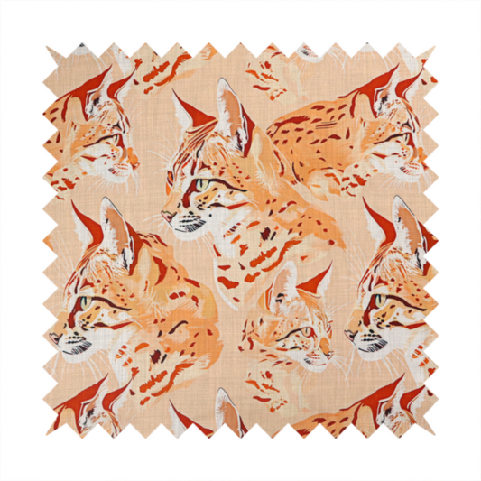 A repeating pattern of illustrated wild cat heads, such as lynxes or bobcats, in shades of orange and cream on a light peach-coloured fabric with a subtle linen-like texture.