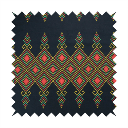 A geometric tribal pattern featuring red, yellow, and green diamonds and linear motifs on a dark charcoal-black fabric background.