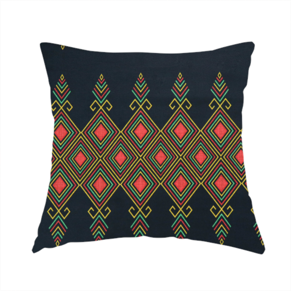 The fabric used to create this handmade cushion is a geometric tribal pattern featuring red, yellow, and green diamonds and linear motifs on a dark charcoal-black fabric background.