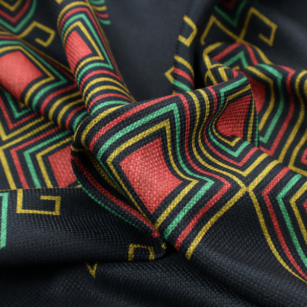 A geometric tribal pattern featuring red, yellow, and green diamonds and linear motifs on a dark charcoal-black fabric background.