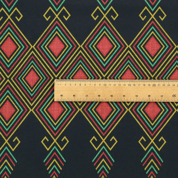 A geometric tribal pattern featuring red, yellow, and green diamonds and linear motifs on a dark charcoal-black fabric background.