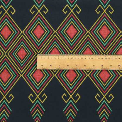 A geometric tribal pattern featuring red, yellow, and green diamonds and linear motifs on a dark charcoal-black fabric background.