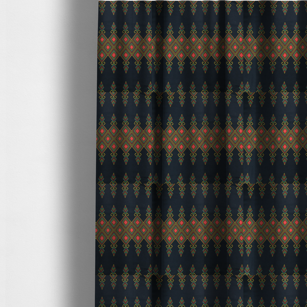 The fabric used to create these made-to-measure curtains is a geometric tribal pattern featuring red, yellow, and green diamonds and linear motifs on a dark charcoal-black fabric background.