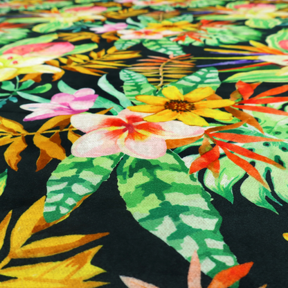A vivid tropical botanical pattern featuring lilies, birds of paradise, and pink plumeria blossoms set against lush green leaves on a deep midnight black background.