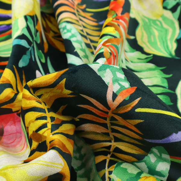A vivid tropical botanical pattern featuring lilies, birds of paradise, and pink plumeria blossoms set against lush green leaves on a deep midnight black background.