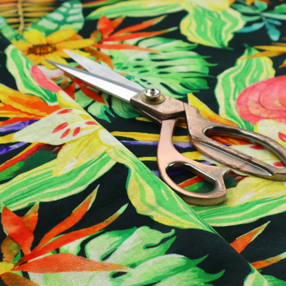 A vivid tropical botanical pattern featuring lilies, birds of paradise, and pink plumeria blossoms set against lush green leaves on a deep midnight black background.