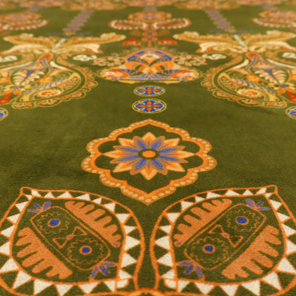 An intricate, bohemian-inspired pattern featuring ornate paisley motifs and stylized floral medallions in warm ochre, terracotta, and cerulean blue on a rich olive green background.