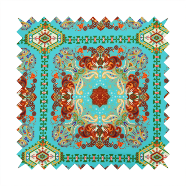 A vibrant and detailed ornamental fabric on a bright turquoise-azure background. The design features a large, symmetrical Persian-style medallion composed of warm terracotta, orange, and gold paisley motifs, framed by vertical geometric borders and diamond-shaped emblems in emerald green and ivory.