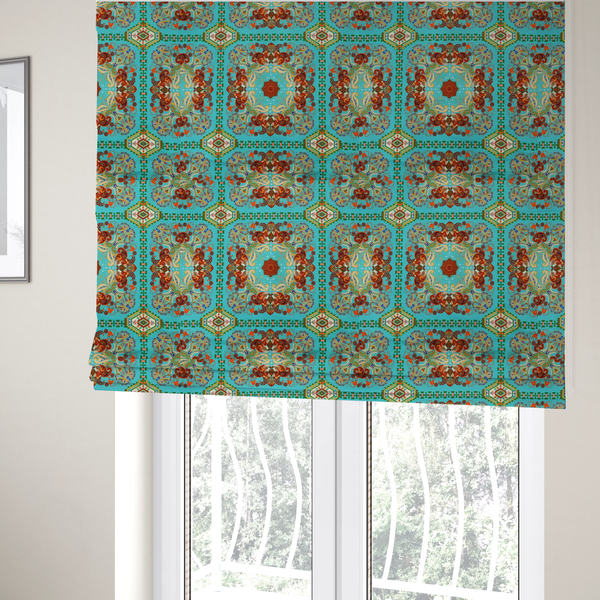 The fabric used to create these Roman blinds is a vibrant and detailed ornamental fabric on a bright turquoise-azure background. The design features a large, symmetrical Persian-style medallion composed of warm terracotta, orange, and gold paisley motifs, framed by vertical geometric borders and diamond-shaped emblems in emerald green and ivory.