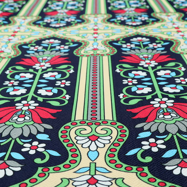 This fabric is a highly detailed, symmetrical textile pattern with a dark navy blue background. The design consists of repeating vertical floral motifs arranged in columns, separated by narrow, light-coloured striped bands.
