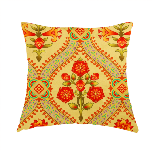 The fabric used to create this handmade cushion is an ornate Gothic Revival fabric pattern featuring red and orange Tudor rose medallions framed by a gold ogival diamond lattice with teal accents.