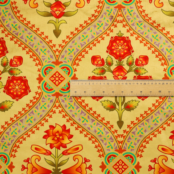 Ornate Gothic Revival fabric pattern featuring red and orange Tudor rose medallions framed by a gold ogival diamond lattice with teal accents.