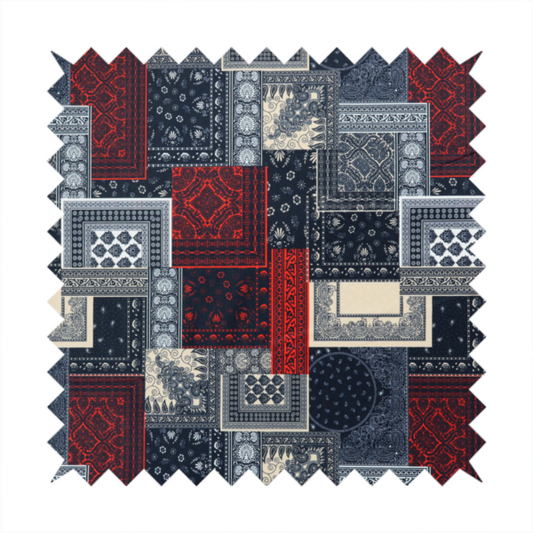 A patchwork-style fabric print featuring a repetitive arrangement of square and rectangular blocks. Each block is filled with intricate navy blue, red, and cream-coloured bandana and paisley motifs, creating a dense, geometric, and traditional textile pattern.