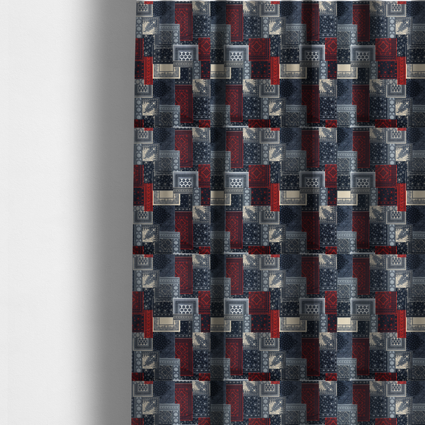 The fabric used to create these made-to-measure curtains is a patchwork-style fabric print featuring a repetitive arrangement of square and rectangular blocks. Each block is filled with intricate navy blue, red, and cream-coloured bandana and paisley motifs, creating a dense, geometric, and traditional textile pattern.