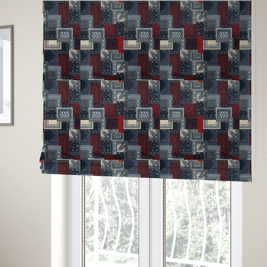 The fabric used to create these Roman blinds is a patchwork-style fabric print featuring a repetitive arrangement of square and rectangular blocks. Each block is filled with intricate navy blue, red, and cream-coloured bandana and paisley motifs, creating a dense, geometric, and traditional textile pattern.