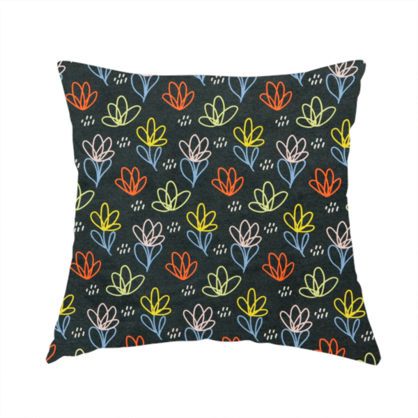 The fabric used to create this handmade cushion is a black fabric print featuring a modern, repeating pattern of colourful doodle-style floral outlines. The flowers are drawn in vibrant yellow, orange, pink, and light blue, accented by small white dash marks, creating a playful and artistic aesthetic.
