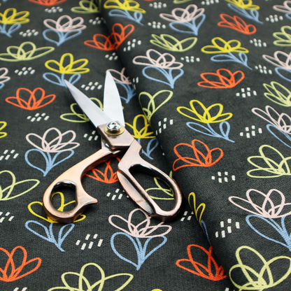 A black fabric print featuring a modern, repeating pattern of colourful doodle-style floral outlines. The flowers are drawn in vibrant yellow, orange, pink, and light blue, accented by small white dash marks, creating a playful and artistic aesthetic.