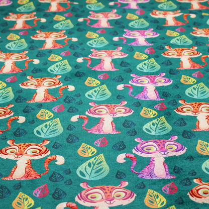 A teal fabric print featuring a whimsical, repeating pattern of cute, cartoon-style baby tigers and stylized leaves. The tigers are rendered in vibrant shades of pink, orange, and purple, while the leaves appear in varied hues, creating a playful and colourful jungle-themed aesthetic.