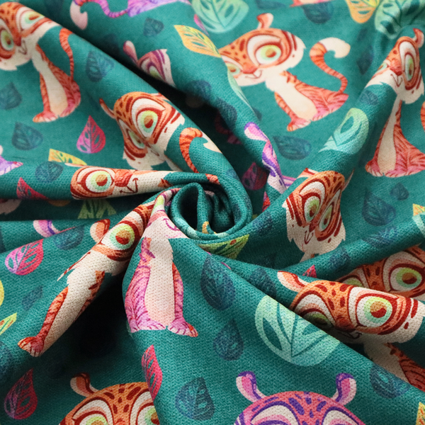 A teal fabric print featuring a whimsical, repeating pattern of cute, cartoon-style baby tigers and stylized leaves. The tigers are rendered in vibrant shades of pink, orange, and purple, while the leaves appear in varied hues, creating a playful and colourful jungle-themed aesthetic.