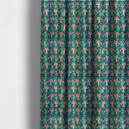 The fabric used to create these made-to-measure curtains is a teal fabric print featuring a whimsical, repeating pattern of cute, cartoon-style baby tigers and stylized leaves. The tigers are rendered in vibrant shades of pink, orange, and purple, while the leaves appear in varied hues, creating a playful and colourful jungle-themed aesthetic.