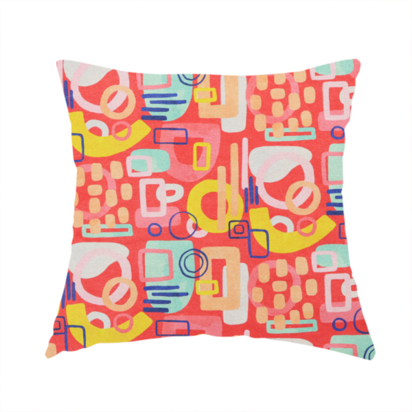The fabric used to create this handmade cushion is a vibrant fabric print featuring an abstract, mid-century modern design. The pattern consists of overlapping geometric shapes—circles, rectangles, and arches—in a lively palette of coral, bright yellow, teal, and soft peach on a coral-red background, creating a playful and retro aesthetic.