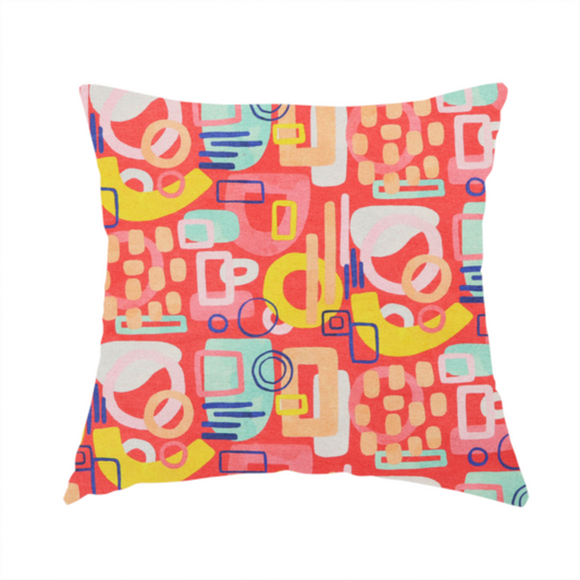 The fabric used to create this handmade cushion is a vibrant fabric print featuring an abstract, mid-century modern design. The pattern consists of overlapping geometric shapes—circles, rectangles, and arches—in a lively palette of coral, bright yellow, teal, and soft peach on a coral-red background, creating a playful and retro aesthetic.
