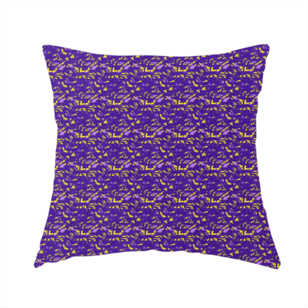The fabric used to create this handmade cushion is a vibrant fabric print featuring a dense, abstract pattern of bright yellow, sharp-edged shapes scattered across a deep, solid purple background. The design creates a textured, dynamic, and modern look.