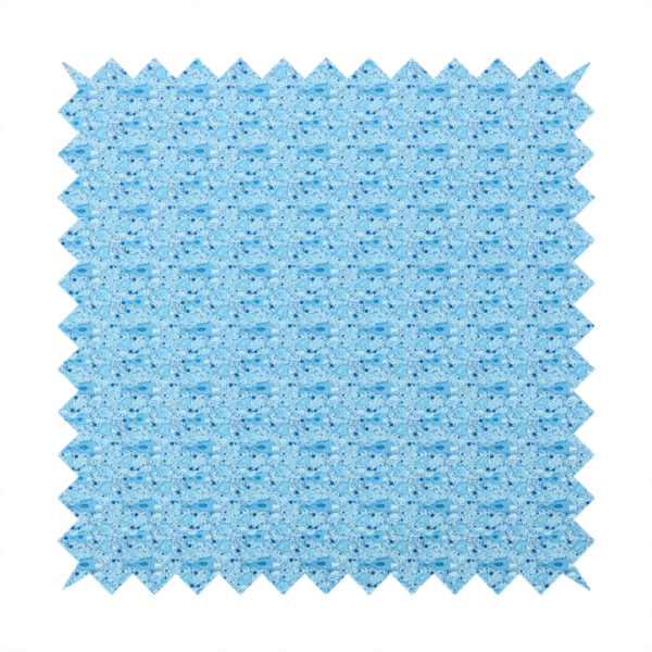A light blue fabric print featuring a repetitive, minimalist pattern of tiny whales and scattered bubbles. The design uses varying shades of blue to create a soft, calming, and playful aquatic aesthetic.