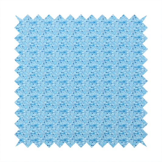 A light blue fabric print featuring a repetitive, minimalist pattern of tiny whales and scattered bubbles. The design uses varying shades of blue to create a soft, calming, and playful aquatic aesthetic.