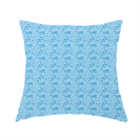 The fabric used to create this handmade cushion is a light blue fabric print featuring a repetitive, minimalist pattern of tiny whales and scattered bubbles. The design uses varying shades of blue to create a soft, calming, and playful aquatic aesthetic.