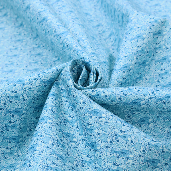 A light blue fabric print featuring a repetitive, minimalist pattern of tiny whales and scattered bubbles. The design uses varying shades of blue to create a soft, calming, and playful aquatic aesthetic.