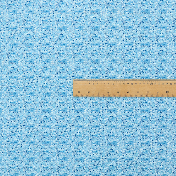 A light blue fabric print featuring a repetitive, minimalist pattern of tiny whales and scattered bubbles. The design uses varying shades of blue to create a soft, calming, and playful aquatic aesthetic.