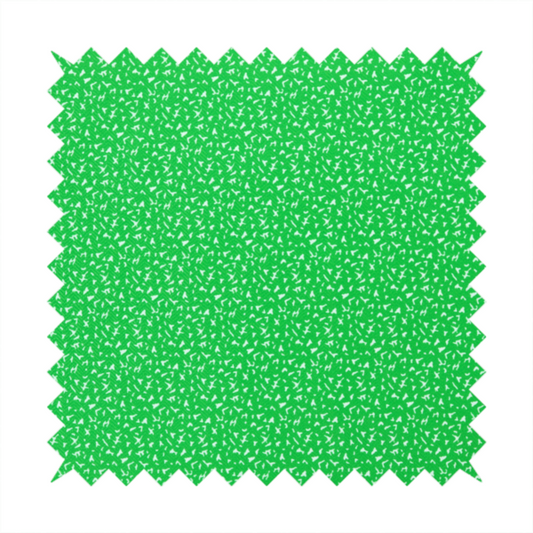 A bright, vibrant green fabric print featuring a repetitive, minimalist pattern of small, white, irregular flecks or specks. The design creates a textured, clean, and modern look.