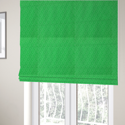 The fabric used to create these Roman blinds is a bright, vibrant green fabric print featuring a repetitive, minimalist pattern of small, white, irregular flecks or specks. The design creates a textured, clean, and modern look.