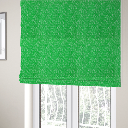 The fabric used to create these Roman blinds is a bright, vibrant green fabric print featuring a repetitive, minimalist pattern of small, white, irregular flecks or specks. The design creates a textured, clean, and modern look.