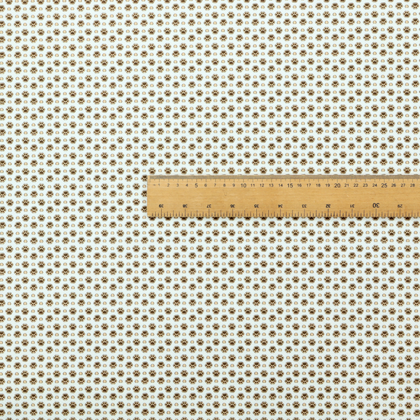 Micro-scale ditsy fabric pattern featuring rows of tiny brown paw prints and beige hearts arranged in a dense polka dot grid on a pale blue background.