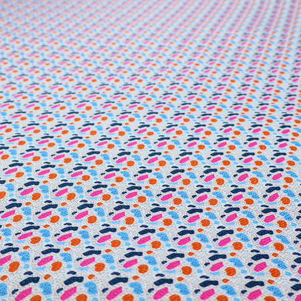 This fabric features a playful, confetti-inspired terrazzo pattern set against a light grey, speckled background.