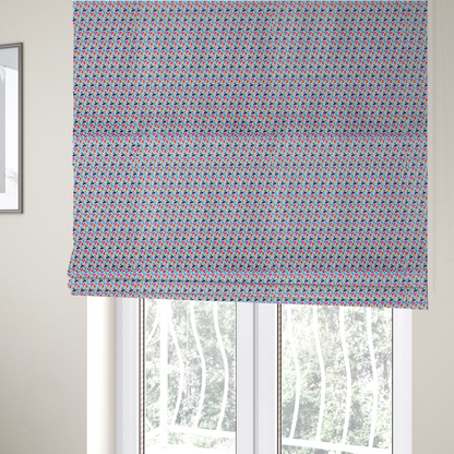 The fabric used to create these Roman blinds is a fabric features a playful, confetti-inspired terrazzo pattern set against a light grey, speckled background.