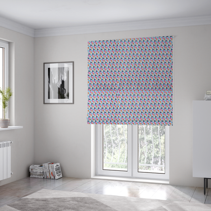 The fabric used to create these Roman blinds is a fabric features a playful, confetti-inspired terrazzo pattern set against a light grey, speckled background.