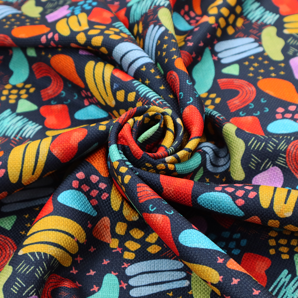 This fabric features a lively, abstract pattern set against a deep navy background. The design is filled with a dense, colourful array of hand-drawn shapes, including squiggles, small arches, and organic blobs in a vibrant palette of yellow, red, orange, teal, light blue, and purple.