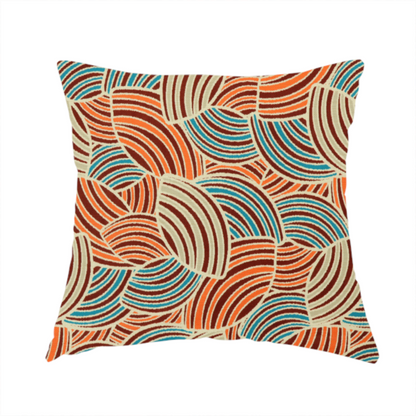 The fabric used to create this handmade cushion is a fabric features a geometric, fan-like pattern composed of overlapping semi-circular arcs. The design creates a dynamic sense of movement through a vibrant colour palette of burnt orange, deep brown, bright turquoise, and cream.
