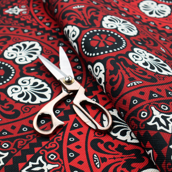 This fabric features an intricate, medallion-style damask pattern with a striking gothic influence. The design is composed of repeating circular motifs containing ornate, symmetrical floral and fan-shaped elements in cream, set against a dark charcoal-black backdrop.