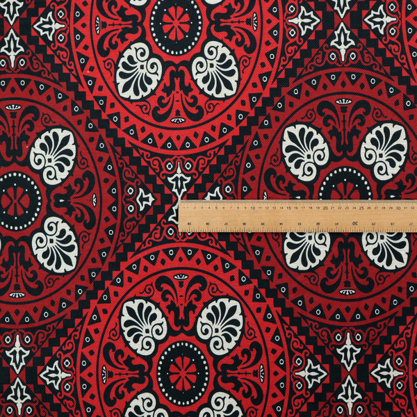 This fabric features an intricate, medallion-style damask pattern with a striking gothic influence. The design is composed of repeating circular motifs containing ornate, symmetrical floral and fan-shaped elements in cream, set against a dark charcoal-black backdrop.