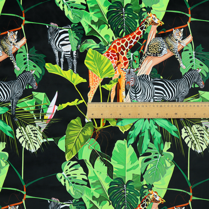 This fabric features a lush, vibrant jungle scene set against a deep black background. The pattern is filled with a dense variety of tropical foliage, including large monstera and palm leaves in multiple shades of green.