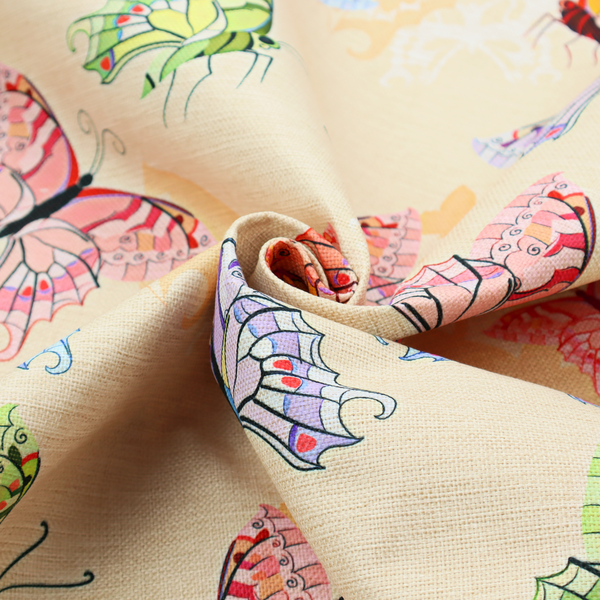 This fabric features a whimsical, repeating pattern of colourful butterflies scattered across a light beige, textured background. The butterflies are rendered in various sizes and a vibrant colour palette, including shades of pink, purple, lime green, and soft blue, with delicate black wing detailing.