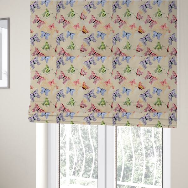 The fabric used to create these Roman blinds is a fabric features a whimsical, repeating pattern of colourful butterflies scattered across a light beige, textured background. The butterflies are rendered in various sizes and a vibrant colour palette, including shades of pink, purple, lime green, and soft blue, with delicate black wing detailing.