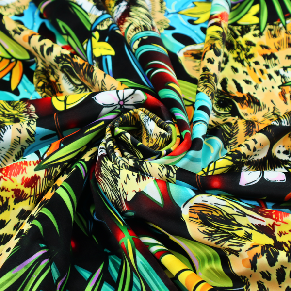 This fabric features a bold, artistic jungle-themed pattern set against a dark black background. The design is a dense, repeating collage of wildlife portraits, featuring alternating heads of leopards and tigers with intense, detailed expressions.