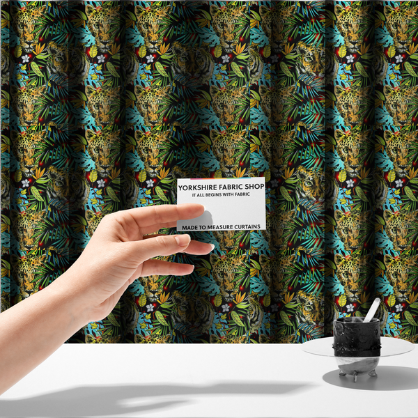 The fabric used to create these made-to-measure curtains is a fabric features a bold, artistic jungle-themed pattern set against a dark black background. The design is a dense, repeating collage of wildlife portraits, featuring alternating heads of leopards and tigers with intense, detailed expressions.
