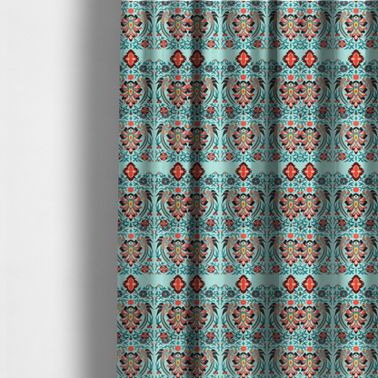 The fabric used to create these made-to-measure curtains is a fabric features an intricate, symmetrical folk-art inspired pattern set against a soft, light turquoise background. The design showcases stylized birds facing toward central, ornate floral bursts, rendered in a bold colour palette of vibrant red, deep orange, teal, and charcoal.